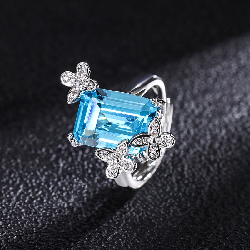 Title: Elegant Blue Topaz Ring with Floral Diamond Accents – Sterling Silver Adjustable Ring for Women